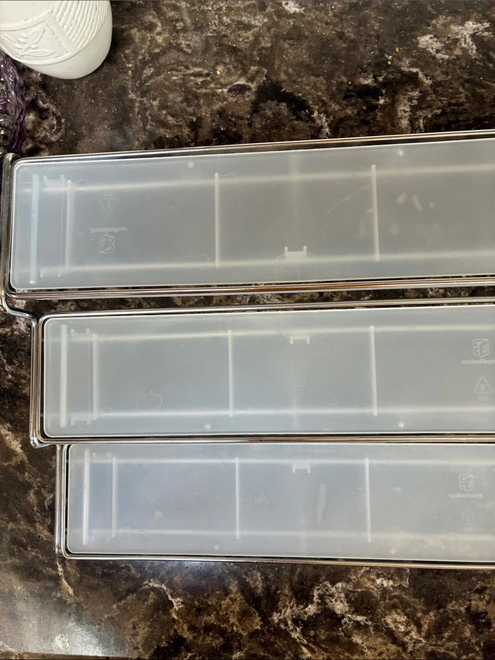 Clear plastic & metal display shelves slide together